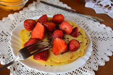 Sweet homemade pancakes with strawberries and chocolate. 