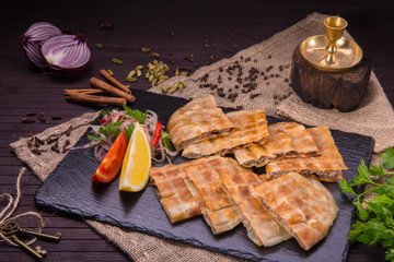 The Arab flat cake fried on coals with forcemeat from mutton
