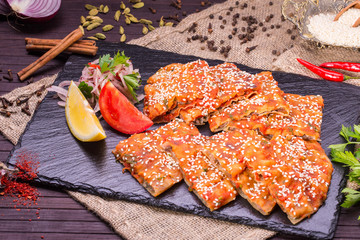 The fried spicy flat cake with sesame powder and forcemeat from mutton
