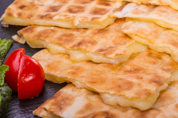 The fried flat cake with cheese the Mozzarella, is served with fresh vegetables