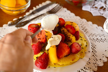 Sweet homemade pancakes with apricots, strawberries, cream cheese and chocolate. 