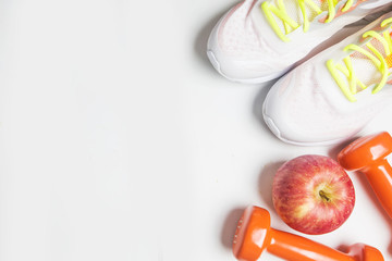 Fitness background with bottle of water, dumbbells and smartphone. View from above