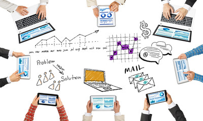 Top view of businesspeople sitting at table and using gadgets