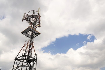 Transmitters and aerials on telecommunication tower during sunset