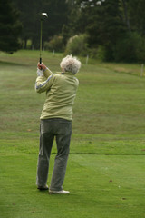Woman golfer teeing off,Agate Beach  Newport, Oregon coast