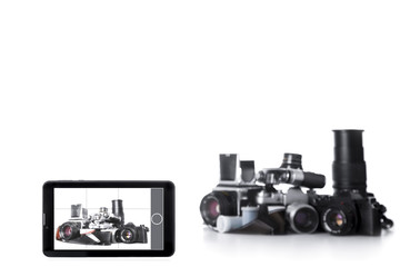 Tablet PC photo camera and heap old film cameras. White background. Technology progress concept.