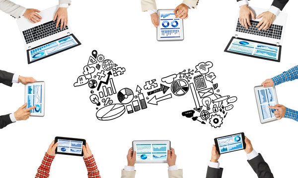 Top view of businesspeople sitting at table and using gadgets