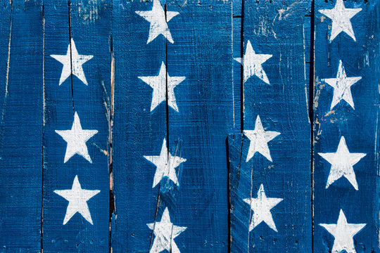 White stars on blue painted on rustic boards. Background for July 4th, Memorial Day, Veterans Day or other patriotic occasion.