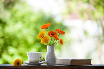 tea still life with books and Calendula
