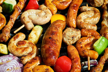 Assorted types of meat and vegetables on the grill