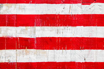 Red and white stripes painted on rustic wood boards. Background for July 4th, Memorial Day,...