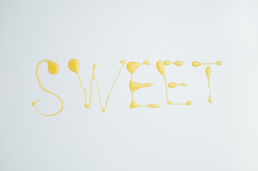 Sweet inscription written with honey on white