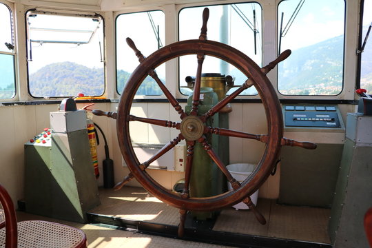 Wooden steering wheel on the ship, navigation on Lake Como, Italy