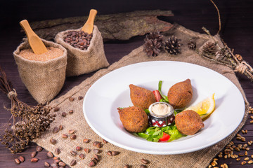 Fried meat meatballs from stewed grains of wheat with stuffing of mutton forcemeat, onions and pine nuts
