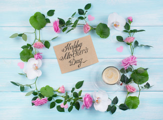 Floral frame consists of roses and orchid flowers and coffee cup with card for Mothers day
