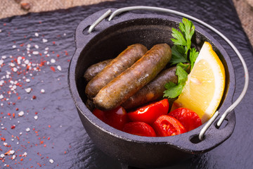 The sausages fried on coals are served with addition of onions, spices, garlic and cilantro