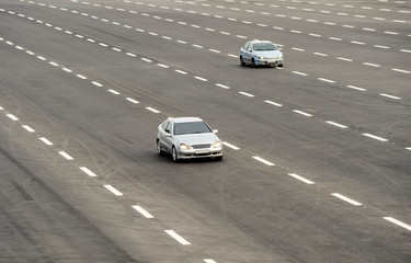 Fototapeta na wymiar Cars drive in highway lanes