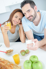 Obraz na płótnie Canvas a happy couple eats breakfast together
