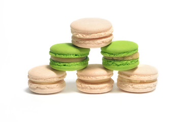 Green and beige macaroons isolated on white
