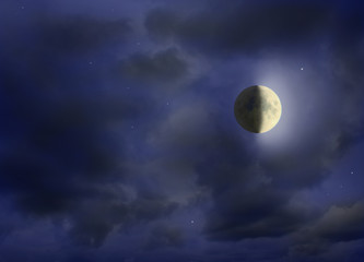 Moon glowing in the dark night sky