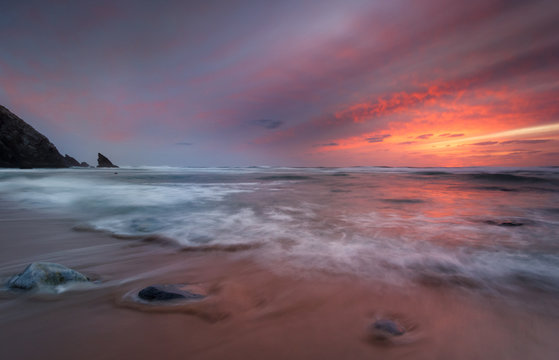 Contrast of a stormy sunset on isolated and nature beach