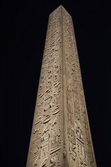 Ancient egyptian obelisk in temple at night