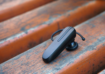 bluetooth headset lying on a bench