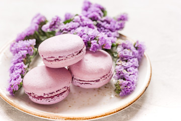 spring woman breakfast with macaroons and mauve flowers white background