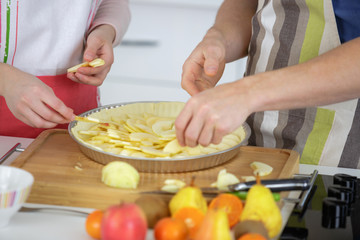 Couple making an apple tart