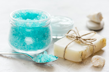 blue spa composition with blue sea salt and natural soap on stone desk background
