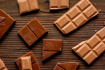 black chocolate pattern on wooden background top view