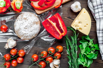 vegetables and cheese for cooking pizza on wooden table background top view