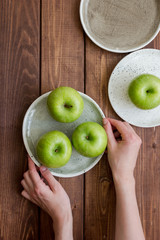 summer food with green apples on wooden background top view