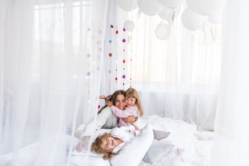 Obraz na płótnie Canvas Woman and children on bed