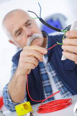 casual senior electrician at work