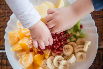 Zelfklevend Fotobehang Children taking fruit from the plate © poplasen
