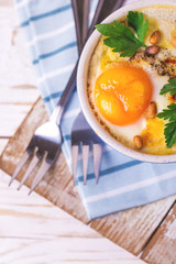 Eggs en Cocotte baked with spinach, parsley and cream.