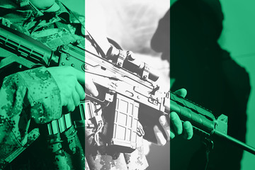Soldier with machine gun with national flag of Nigeria