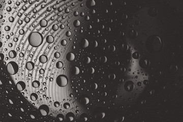 Abstract lines through drops of water on a glass macro 