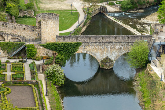 Old medieval bridge in Europe with its reflection on the water. Casemates and stone bridge in Luxembourg