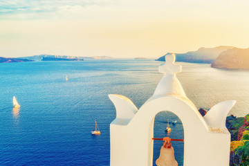 Célèbre point de repère de voyage : Arch avec une cloche à Oia ou Ia à l& 39 île de Santorin, Grèce. Paysage au coucher du soleil. Voiliers en mer Égée et ciel coucher de soleil spectaculaire à l& 39 arrière-plan.