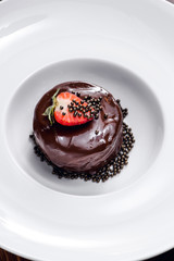 Top view of chocolate dessert with strawberry
