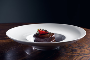 Plate with chocolate dessert and strawberry