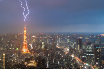 Lightning storm over Tokyo city, Japan in night with thunderbolt over Tokyo tower. Thunderstorm in...