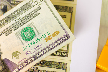 ckose up of Us 20 american dollar money bills spread aroundo over a white background