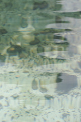 Coins in shallow pool