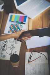 Business people handshake sitting on the desk in office
