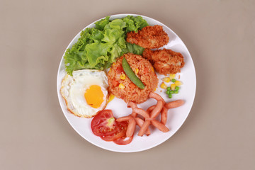 American fried rice topped sunny up,sausage.chicken and herbs