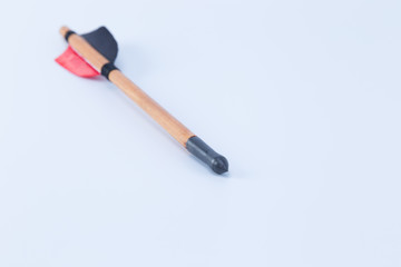 Medieval wood and iron arrow handmade red and black feathers isolated on white background