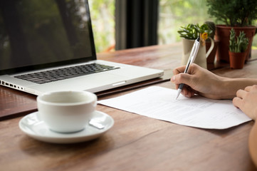 Businesswoman filling on document form
